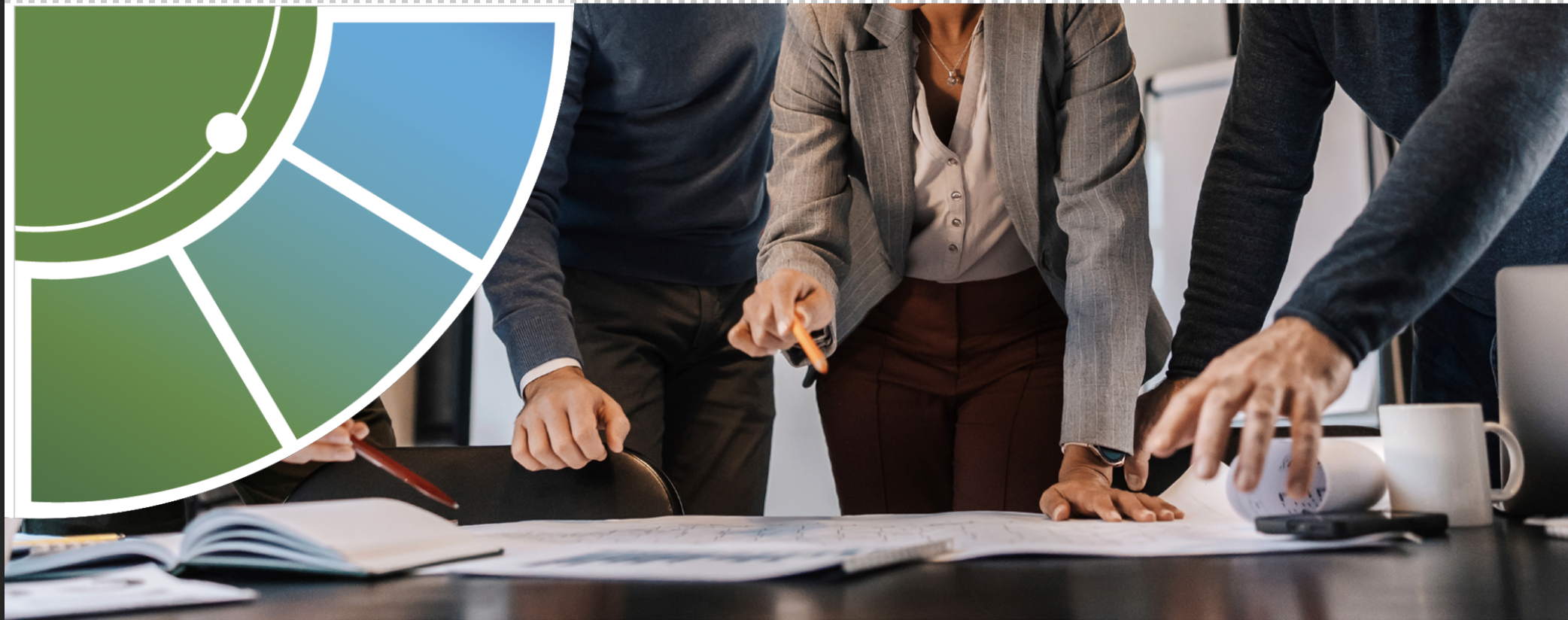 3 people standing over a desk discussing important things.