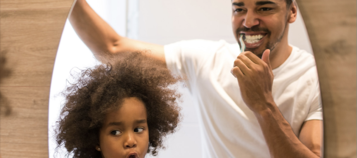 father and son brushing teeth
